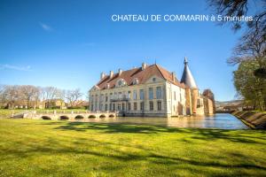 a large building on the water in a park at Clos de Fougères - Cocon in Montoillot