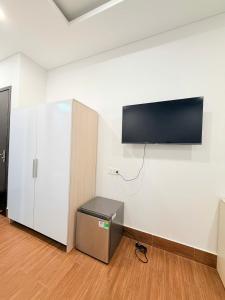 a room with a flat screen tv on a wall at Tropical Bay Villas and Homestay in Phú Quốc