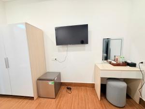 a room with a desk and a tv on the wall at Tropical Bay Villas and Homestay in Phú Quốc +35 photos