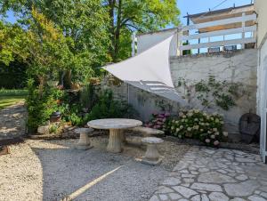 an umbrella sitting on a table in a garden at l'Orée du Bois in Saint-Brice +16 photos