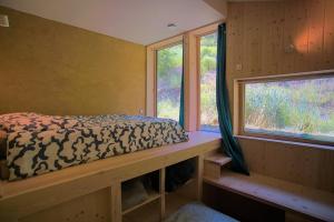a bed in a room with a window at Au Son Du Diois in Die