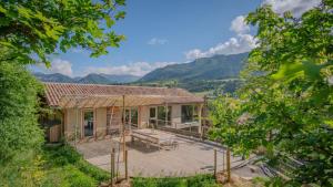 an exterior view of a house with mountains in the background at Au Son Du Diois in Die