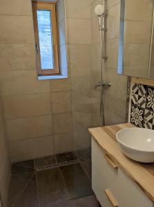 a bathroom with a sink and a shower at Au Son Du Diois in Die