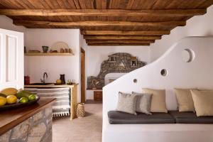a living room with a couch and a bedroom at Infinito Boathouse Milos in Agia Irini Milos