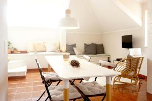 a living room with a white table and chairs at Old Town Apt with Ocean Views in Sesimbra