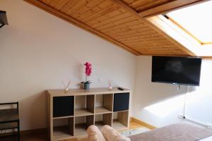 a living room with a flat screen tv on the wall at casa muralla - plaza mayor in Ciudad-Rodrigo