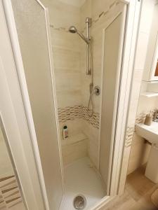 a shower stall in a bathroom with a sink at A casa di Irene in Le Marmore