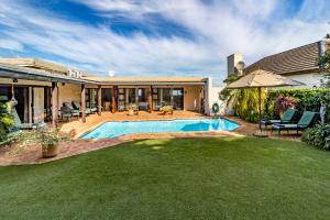 a house with a swimming pool in a yard at Majorca House in Somerset West