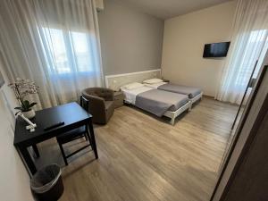 a small bedroom with a bed and a desk at La Culla del Mugello in Scarperia