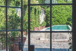 a view of a pool through a window at Villa La Limonera in Casciago +28 photos