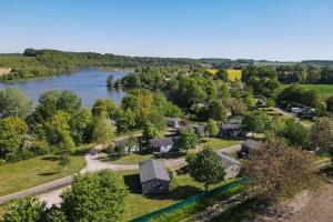an aerial view of a house next to a river at Camping les Coteaux du Lac in Chemillé-sur-Indrois