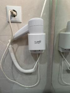 a phone with a cord plugged into a wall at Moradia Ricardo - Nazaré in Nazaré