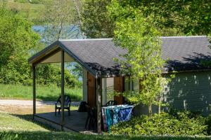 a gazebo with two chairs on a porch at Camping les Coteaux du Lac in Chemillé-sur-Indrois +26 photos