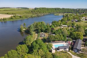 an aerial view of a house and a lake at Camping les Coteaux du Lac in Chemillé-sur-Indrois