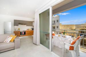 a living room with a couch and a table at Hillock Residence Marsalforn in Marsalforn