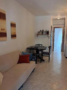 a living room with a couch and a table at Evgenias Beach Escape in Kallithea Halkidikis