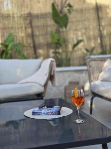 a table with a glass of wine and a drink at Villetta Vista Paradiso in Costa Paradiso