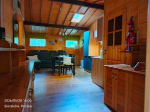 a kitchen and dining room with a table in it at Słowicza Chatka in Sieraków +9 photos