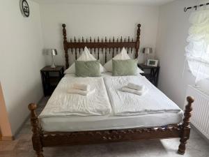 a bedroom with a large bed with two pillows at Ferienwohnung Mutzelmann in Kurort Gohrisch