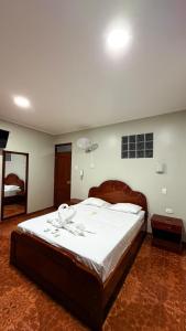 a bedroom with a large bed with white sheets at Horus Suite Hotel in Jaén