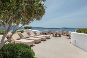 a row of chairs and tables on a patio at Aspaki by Art Maisons in Oia