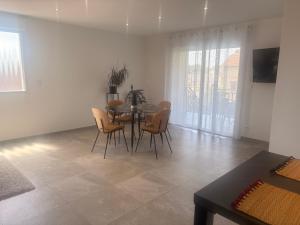 a dining room with a table and chairs at Chez sana in Saint-Dizier