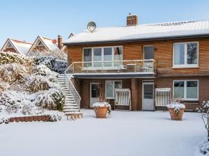 a house with snow on the ground in front of it at Apartment Etta im Dangaster Nest in Varel