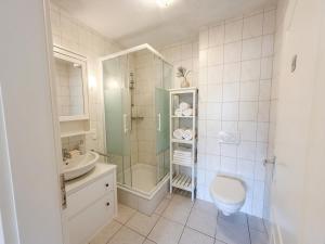 a bathroom with a shower and a toilet and a sink at Apartment Etta im Dangaster Nest in Varel
