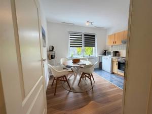a kitchen with a table and chairs in a room at Apartment Etta im Dangaster Nest in Varel