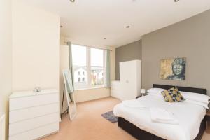 a bedroom with a bed and a large window at Flex Lets - Elms West Apartments in Sunderland