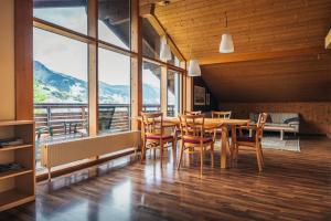a dining room with a table and chairs and mountains at Alpenblick-Raggal in Raggal