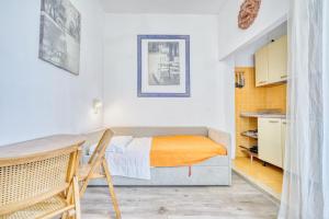 a bedroom with a bed and a table and a kitchen at Hotel Everest - Bar e Ristorante in Gabicce Mare