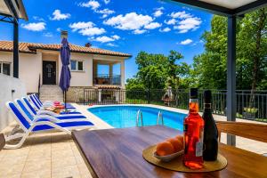 a table with a bottle of wine and a plate of bread at House Luka by Briskva in Krapan