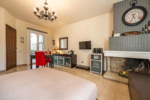 a bedroom with a fireplace and a clock on the wall at Luxi noa in Quartu SantʼElena