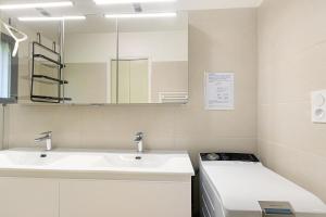 a bathroom with a sink and a mirror at La Clémenguite in Vals-les-Bains +24 photos