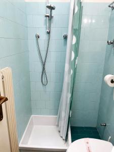 a bathroom with a shower with a tub and a toilet at Vittoria 1920 - hotel restaurant apartaments in Marzio +35 photos