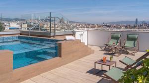 a swimming pool on the roof of a building at Boutique Hotel H10 Montcada in Barcelona