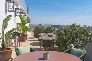 an outdoor patio with tables and chairs and plants at Boutique Hotel H10 Montcada in Barcelona