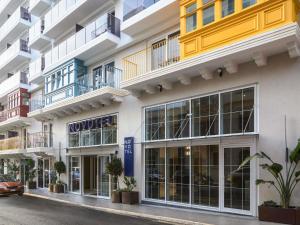 a facade of a building with a hotel at Novotel Malta Sliema in Il-Gżira