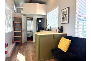 a kitchen with a green island in a tiny house at Near Zion Modern Tiny Home Hiking & MTB Access in Apple Valley