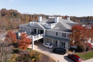 an aerial view of a house with cars parked in the driveway at The Colonies at Williamsburg in Williamsburg