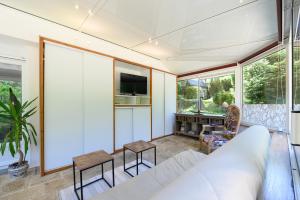 a living room with a white couch and a table at Domaine des légendes in Plumelin