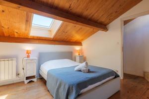 a bedroom with a bed and a skylight at Élégant T3 Terrasse & Wifi in Vals-les-Bains