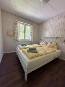 a bedroom with a large bed with two towels on it at Chalet Vallese Valbella Lenzerheide, great view in Valbella