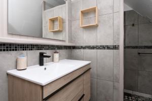 a bathroom with a white sink and a shower at Domaine des légendes in Plumelin +41 photos