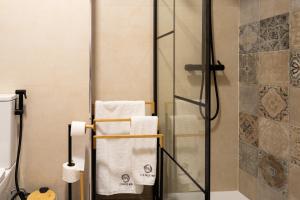 a bathroom with a shower with towels on a rack at Lounge Inn Guest House in Porto +67 photos