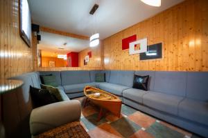 a living room with a blue couch and a table at Hotel A. G. Porcillan in Ribadeo