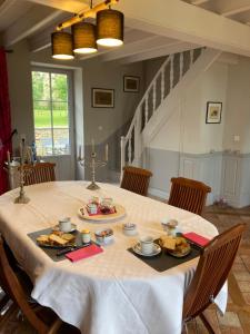 a table with food on it in a room at La Solitude in Bois-de-Cené
