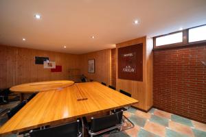 a conference room with a wooden table and chairs at Hotel A. G. Porcillan in Ribadeo