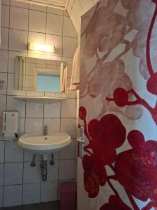 a bathroom with a sink and a red flower mural at GRÜNER HEINRICH - Bett&Frühstück in Oberaichwald +35 photos